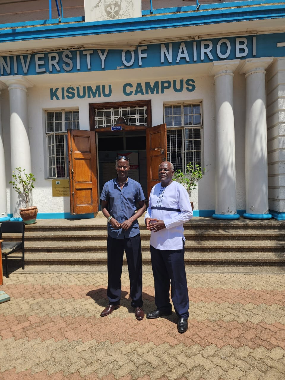 Prof. Kitche Magak of maasai Mara University [L] and BD Njuguna, Registrar,Kisumu Campus